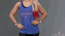 a woman is wearing a blue tank top that says ' orlando ' on it .