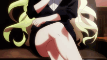 a girl with blonde hair is sitting on a couch