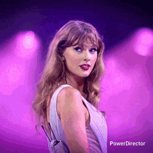 a woman in a white dress is standing in front of a purple background that says power director on the bottom