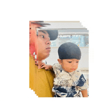 a man is holding a baby in front of a aquarite store