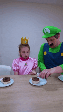 a man dressed as mario and a girl dressed as princess peach are sitting at a table