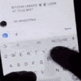 a woman with long black hair is sitting on a bed looking at her phone .