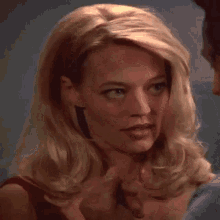 a close up of a woman 's face with a man touching her neck