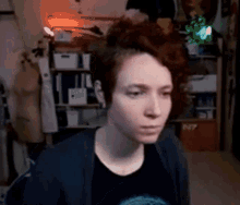 a woman with red hair is sitting in a room .