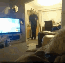a blurred image of a living room with a tv on the wall