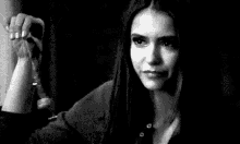 a black and white photo of a woman looking at a man .