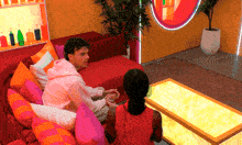 a man and a woman are sitting on a couch in a living room