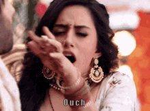 a woman with her mouth open has the word ouch written below her