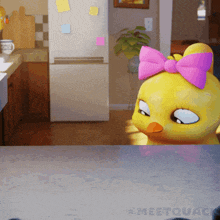 a cartoon duck with a pink bow on its head