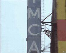 a sign that says ' mcca ' on it in white