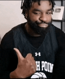 a man with a beard is wearing a basketball jersey that says h point