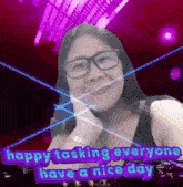a woman with glasses is smiling with the words happy tasking everyone have a nice day behind her