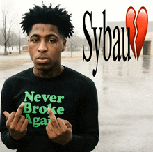 a man wearing a black shirt that says never broke again
