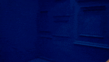 a blonde woman with blue nails is covering her face