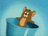 a cartoon mouse is sitting in a blue cup with his arms outstretched
