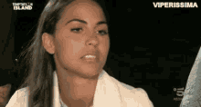 a woman in a white jacket is making a funny face on a tv show .