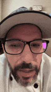 a man wearing glasses and a hat that says ' captain america ' on it