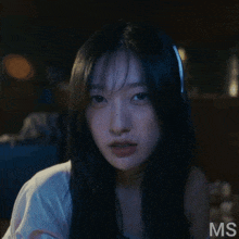 a close up of a woman 's face with the letters ms visible