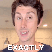 a man making a funny face with the word exactly written on his chest