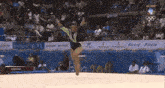 a gymnast performs in front of a banner that says telcel