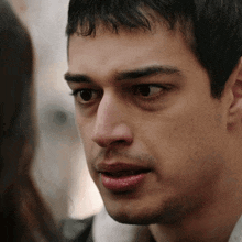 a close up of a man looking at a woman