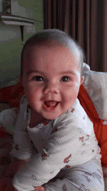 a baby wearing a pajama with a crab on it