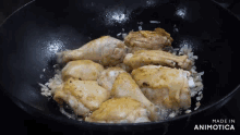 chicken is being cooked in a frying pan and the words made in animotica are visible