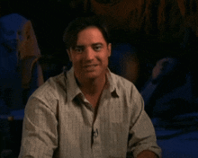 a man in a striped shirt is making a surprised face