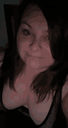 a woman taking a selfie with a black bra on