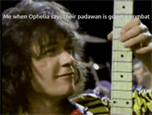 a man holding a guitar with the words " me when ophelia says their padawan is good at combs "