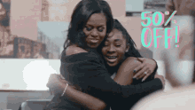 a woman hugging another woman with 50 % off written on the bottom