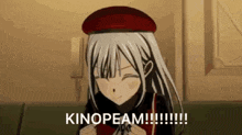 a girl with long white hair is wearing a red hat and smiling while holding a red heart .