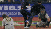 a baseball game is being played in front of a ybels sign