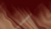 a blurred image of a person 's face on a red background
