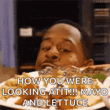 a man is eating a plate of food with the caption how you were looking at it !! mayo and lettuce