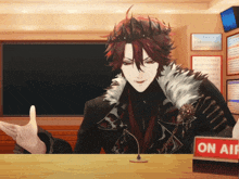 a man with a crown on his head is sitting at a table with a sign that says on air