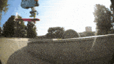 a person is doing a trick on a skateboard in the air