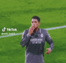 a soccer player wearing a jersey with emirates fly better on it