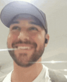 a man with a beard wearing a blue hat