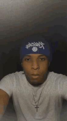 a young man wearing a blue yankees hat
