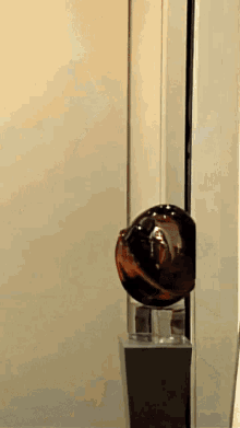 a glass ball is sitting on a green stand