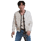 a man wearing a white cardigan and blue jeans