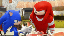 sonic the hedgehog and knuckles the echidna are sitting at a table