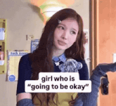 a girl is standing in front of a door holding a teddy bear and talking about going to be okay .