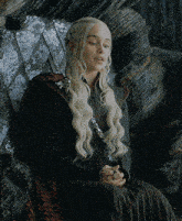 a woman with blonde hair is sitting in a chair