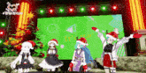 a group of anime girls wearing santa hats are standing in front of a large screen that says ' triple bread ' on it