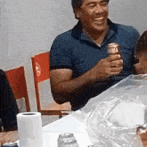 a man is holding a can of brahma beer