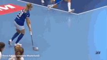 a female floorball player with the name veera kauppi on the bottom
