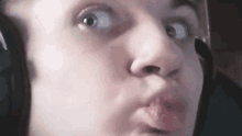 a person wearing headphones is making a funny face .