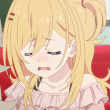 a girl with blonde hair and blue eyes is making a face